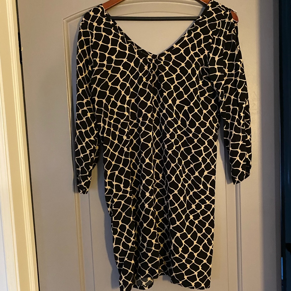 Black/Beige mini dress with open forearm sleeve.